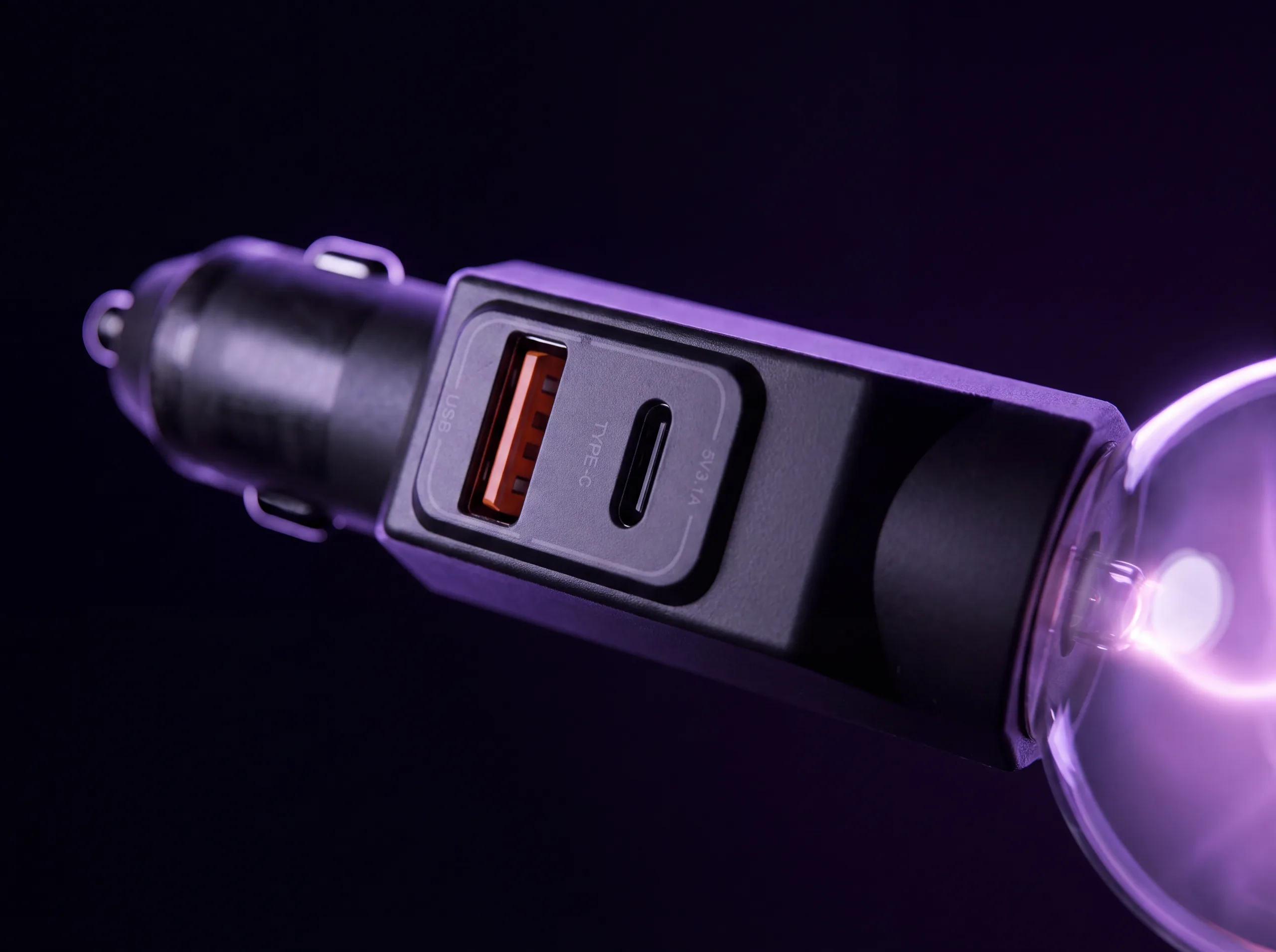 The charger’s recessed port panel in close-up — an orange-tongued USB‑A beside an oval USB‑C, marked 5V 3.1A